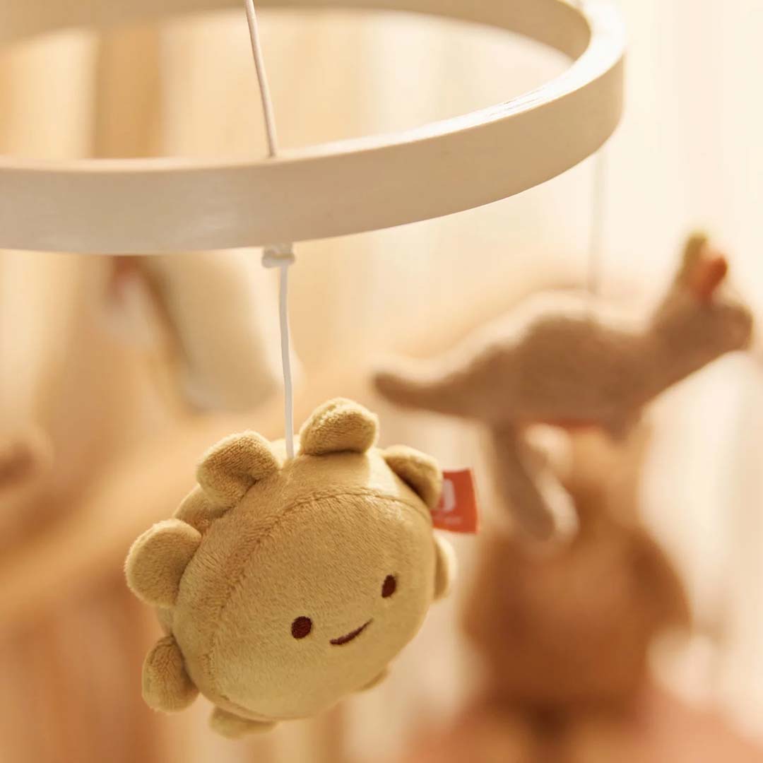 Detail van de Jollein babymobiel met een pluchen zonnetje met een lachend gezichtje.