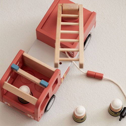 Detailopname van de Kids Concept houten brandweerauto van bovenaf, met de ladder omhoog en twee brandweermannetjes ernaast.