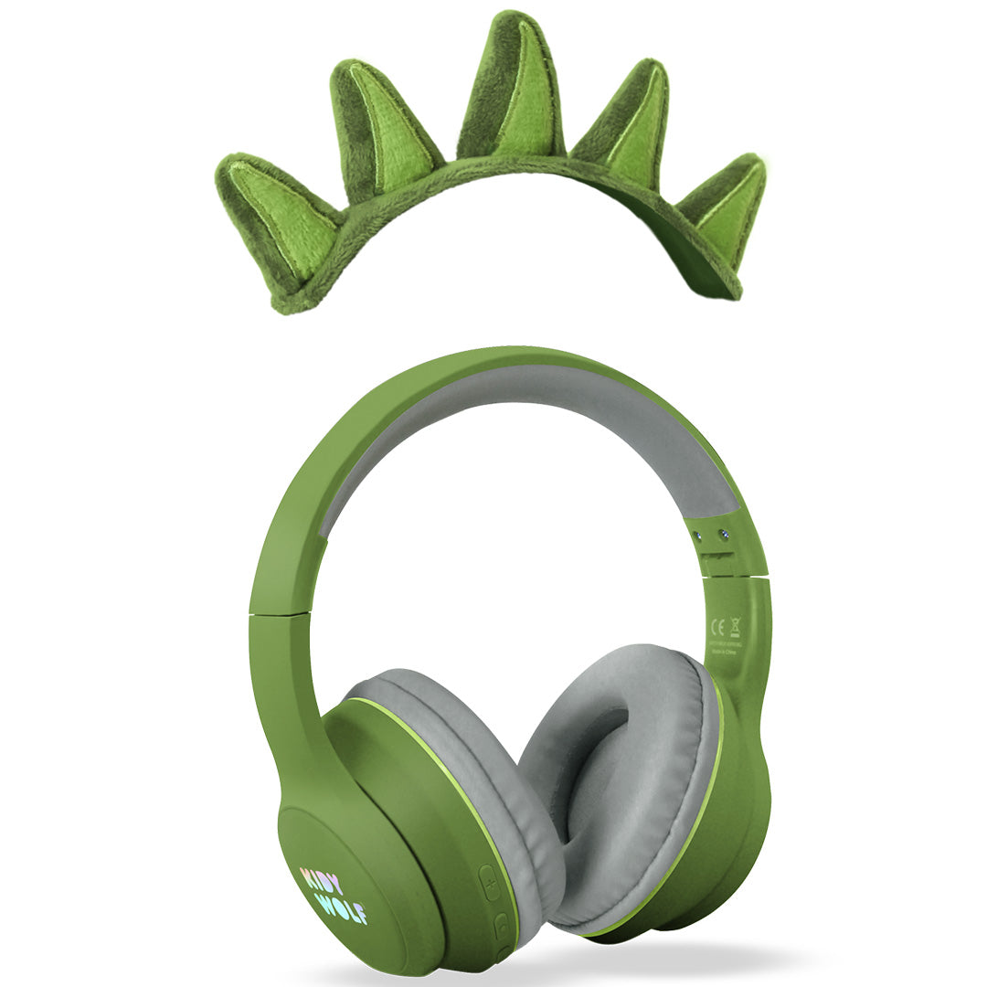 De groene Kidywolf kinderkoptelefoon en de losse dinosaurus-spikes hoofdband liggen naast elkaar.