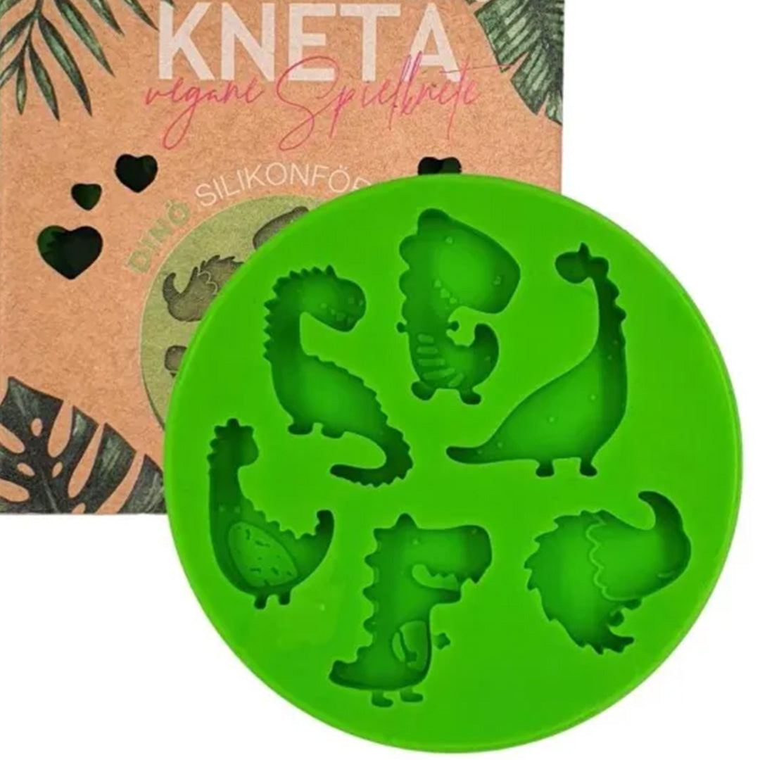 Knetä groene siliconen dinosaurusvorm voor klei, deels zichtbaar met de verpakking.