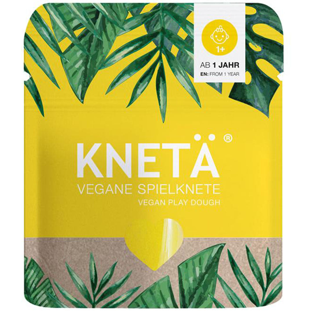 Knetä verpakking van gele vegan speelklei met groene bladeren en de leeftijdsaanduiding 1+.