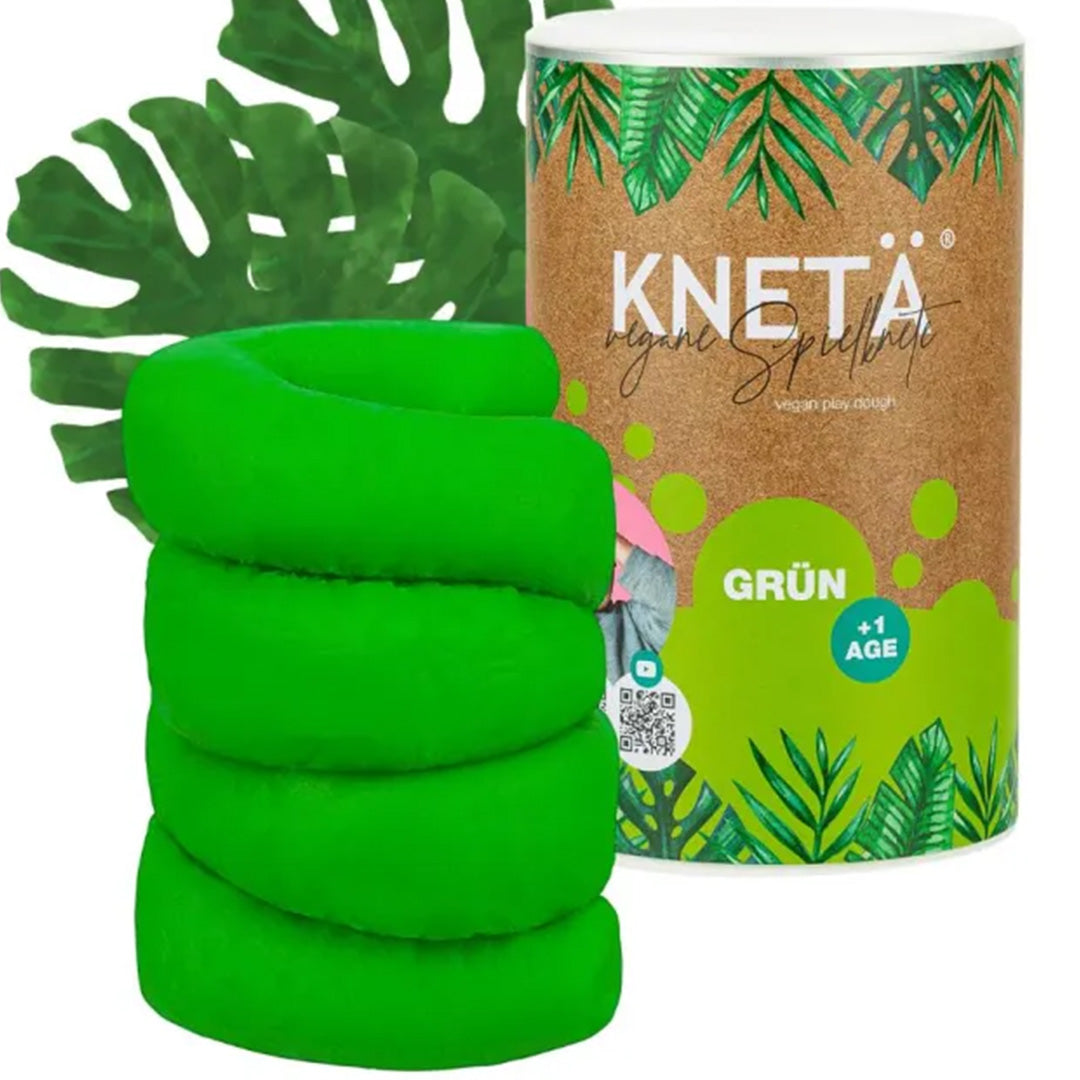 Knetä groene speelklei in een rol naast de groene verpakking met bladerenpatroon.