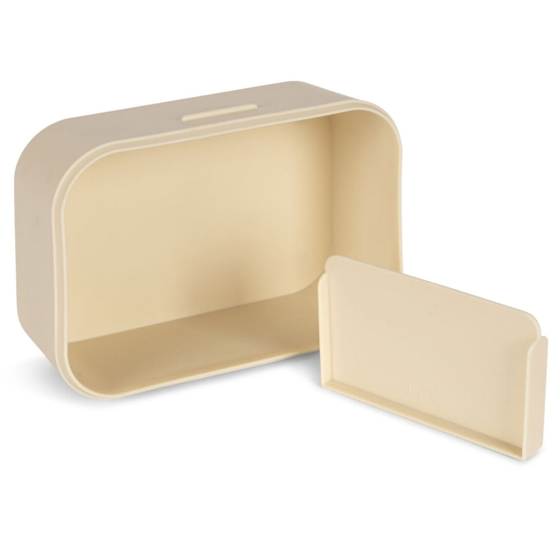Lege Konges Sløjd beige broodtrommel met een losse verdeler ernaast.