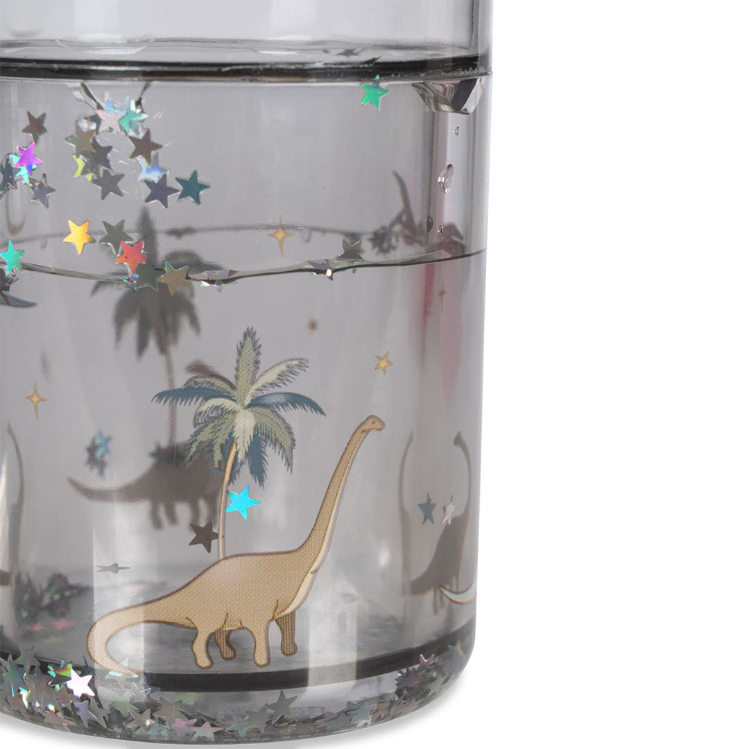 Detail van een Konges Sløjd kinderbeker met een langehalsdino, palmboom en sterren in het water.