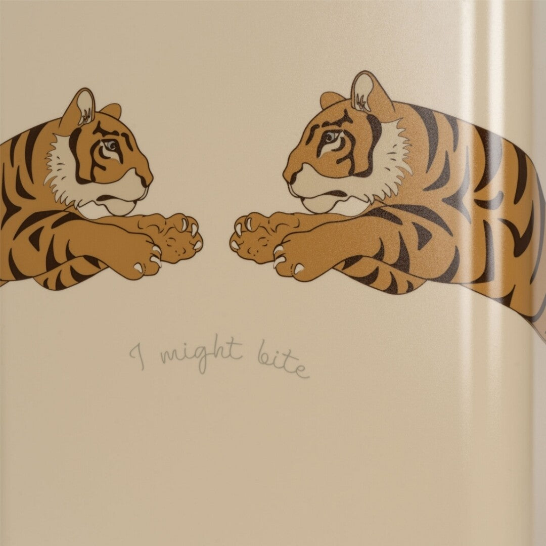 Close-up van de twee tijgers en de tekst "I might bite" op de beige kinderkoffer.