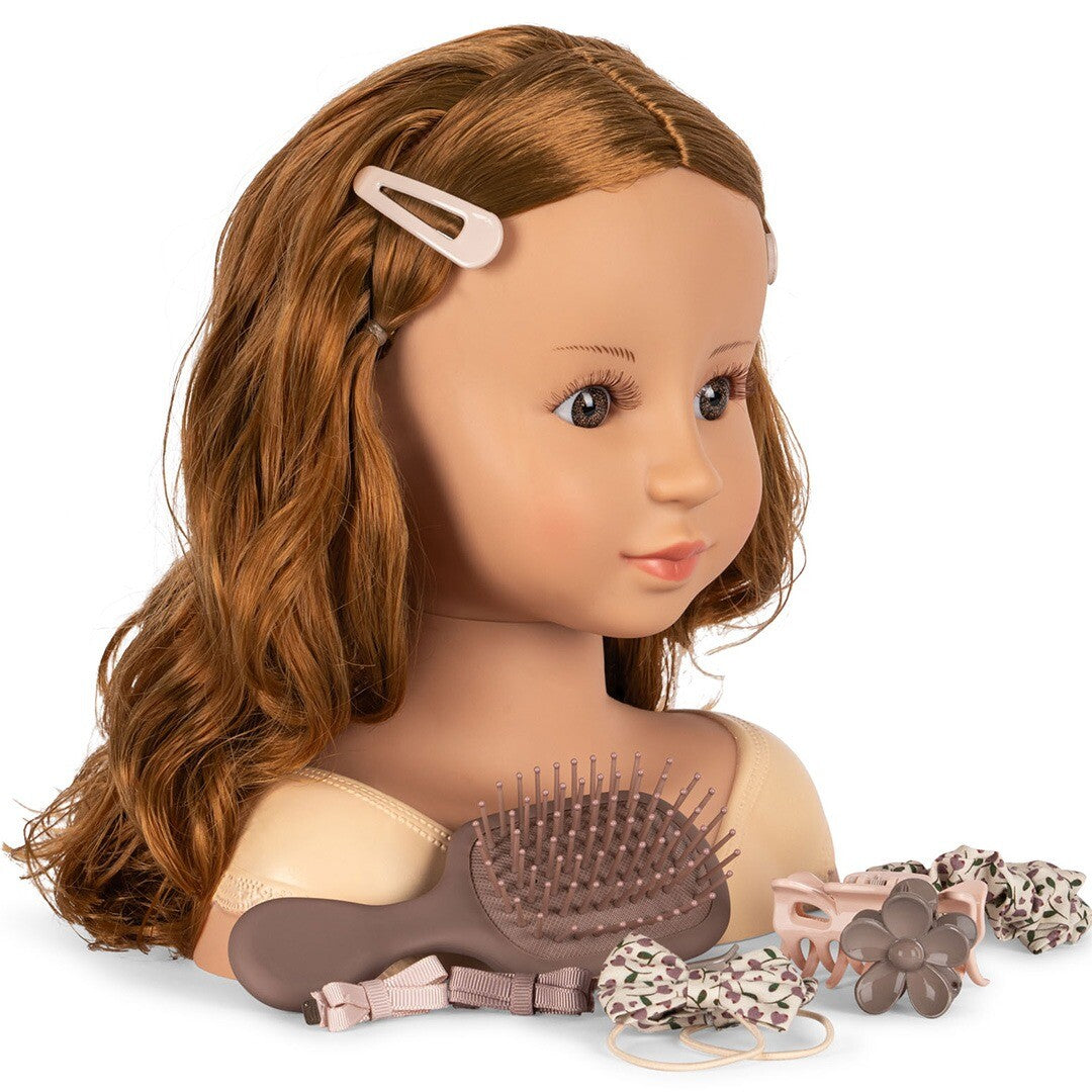 Konges Sløjd styling pop met lang bruin haar, een borstel en diverse haaraccessoires in beige en bruin.
