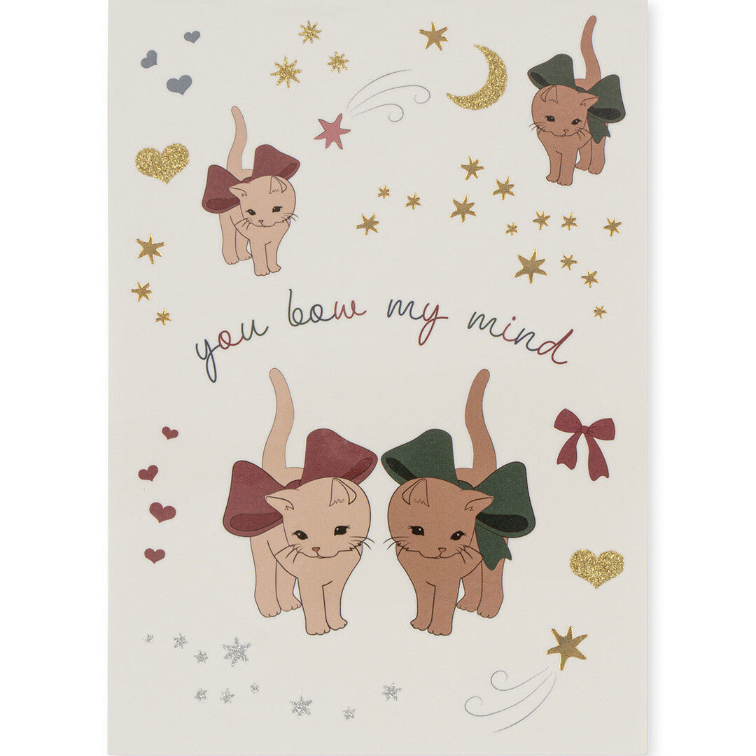 Vel met tijdelijke tatoeages van katten met strikken, sterren, harten en de tekst 'you bow my mind'.