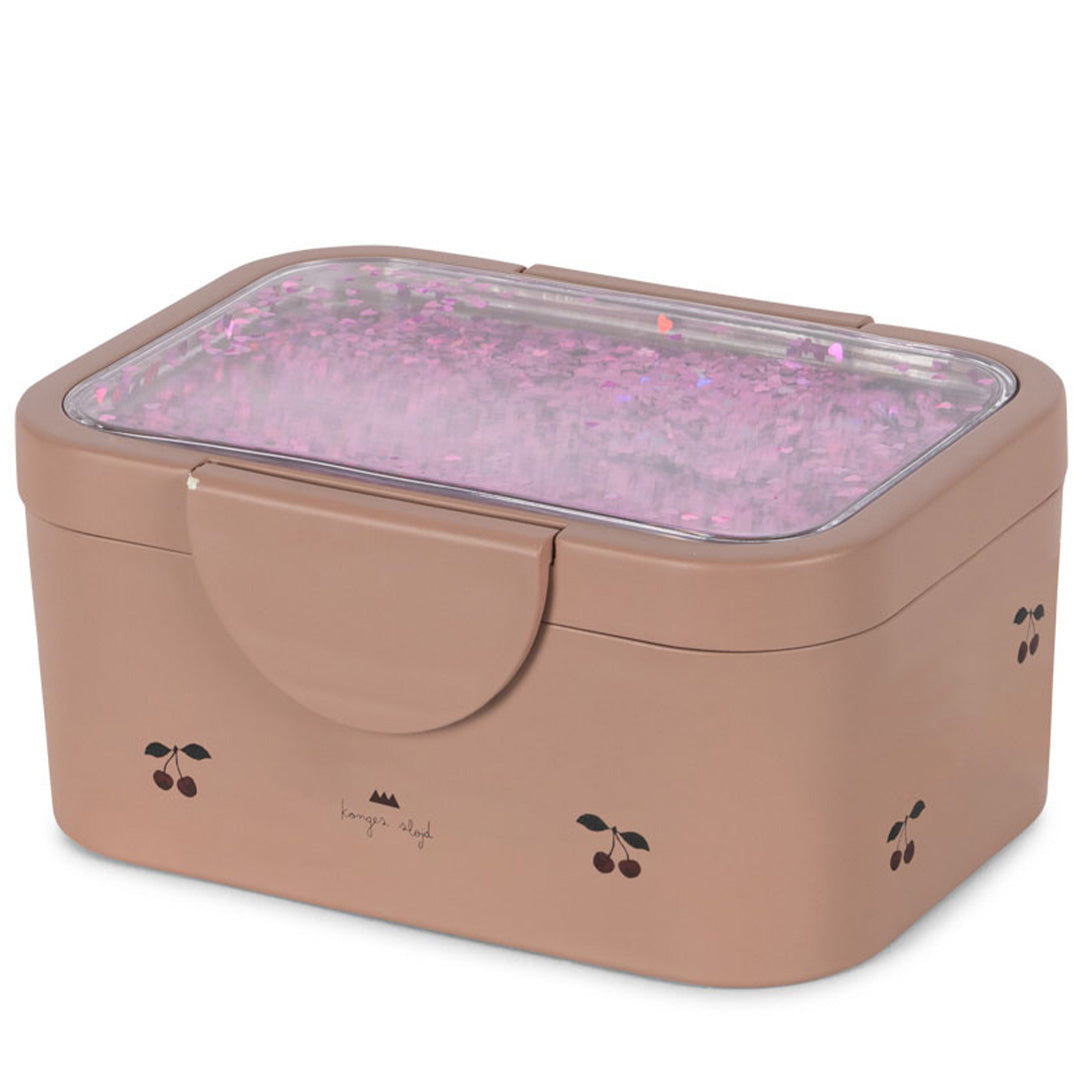 Konges Sløjd broodtrommel voor kinderen in beige met een transparant deksel vol roze glitter en een kersenpatroon.