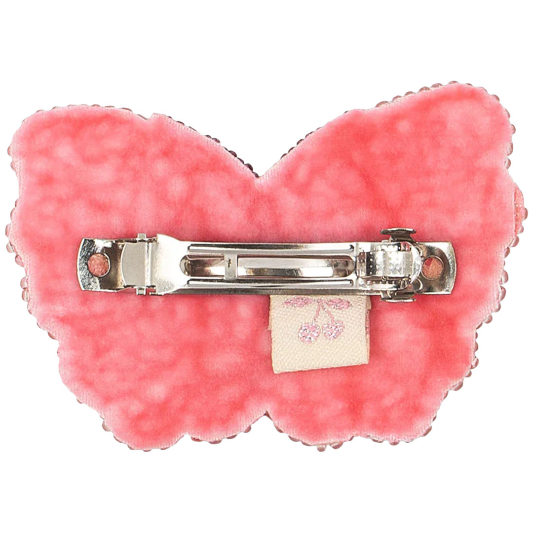 Achterkant van de roze vlinder haarclip met de zilverkleurige metalen klem.