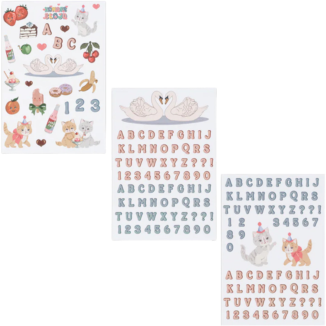 Drie vellen Konges Sløjd 'Back to School' stickers met letters, cijfers, zwanen, katten en diverse etenswaren.