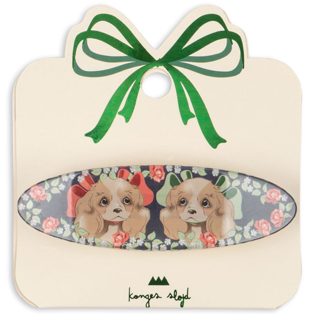 Konges Sløjd haarclip met puppy's en bloemen op een kartonnen verpakking met een groene strik.