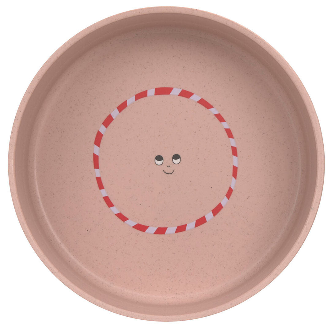 Lässig roze kinderkom van bovenaf gezien met een kattengezichtje en een rood-wit gestreepte cirkel.