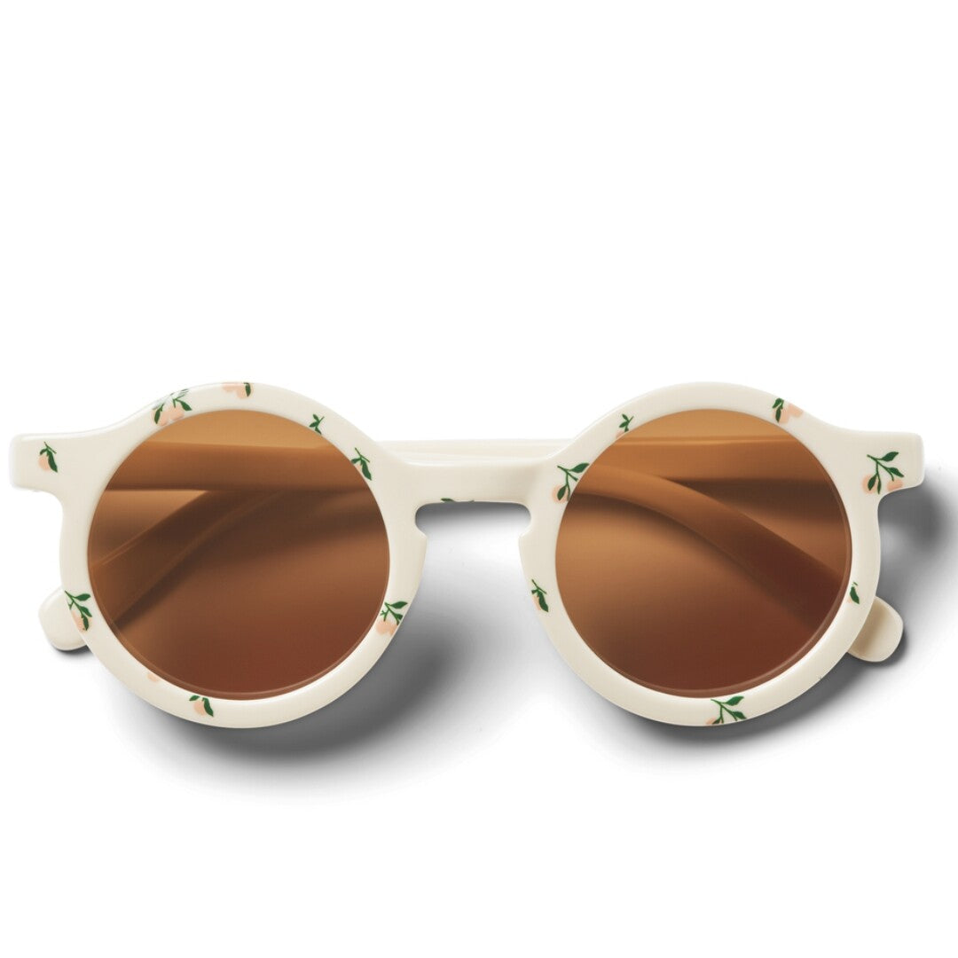 Liewood kinderzonnebril Darla in beige met gebloemd patroon en bruine glazen, van voren gezien.