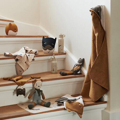 Collectie Liewood producten, waaronder het nachtlampje, op een houten trap.