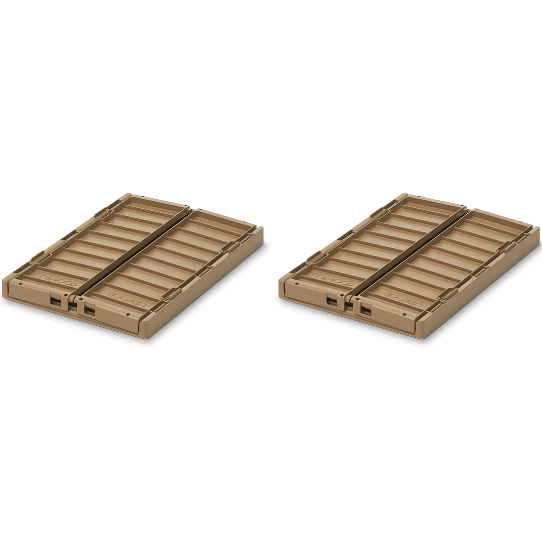 Twee plat opgevouwen Liewood Weston opbergkratten in beige kleur, schuin van bovenaf gefotografeerd.