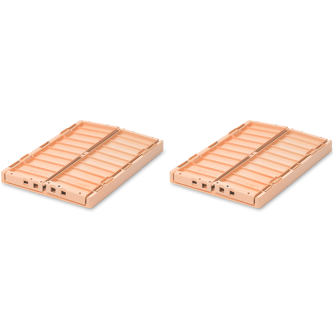 Twee opgevouwen Liewood opbergkratten in de kleur tuscany rose.