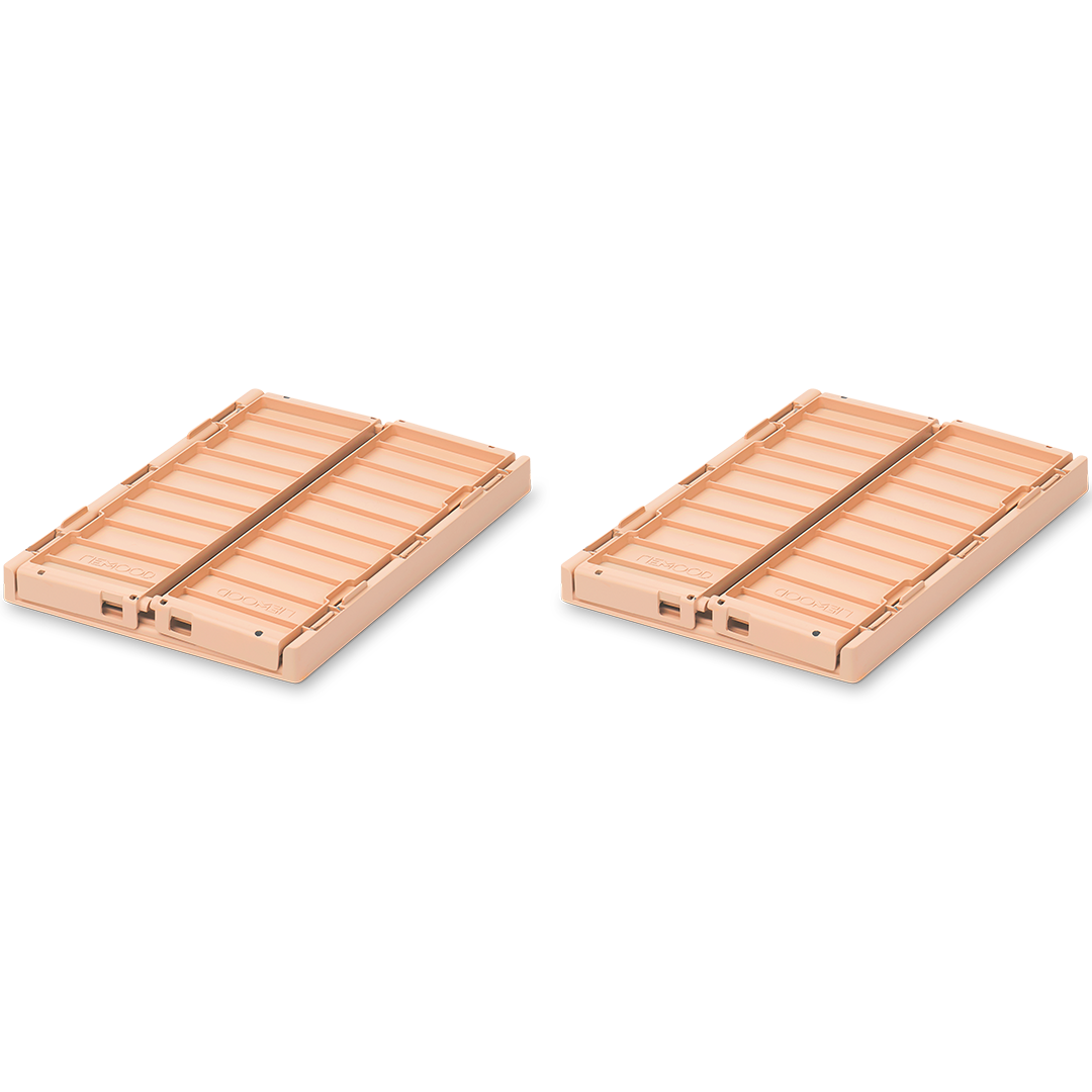 Twee opgevouwen Liewood opbergkratten in de kleur tuscany rose.