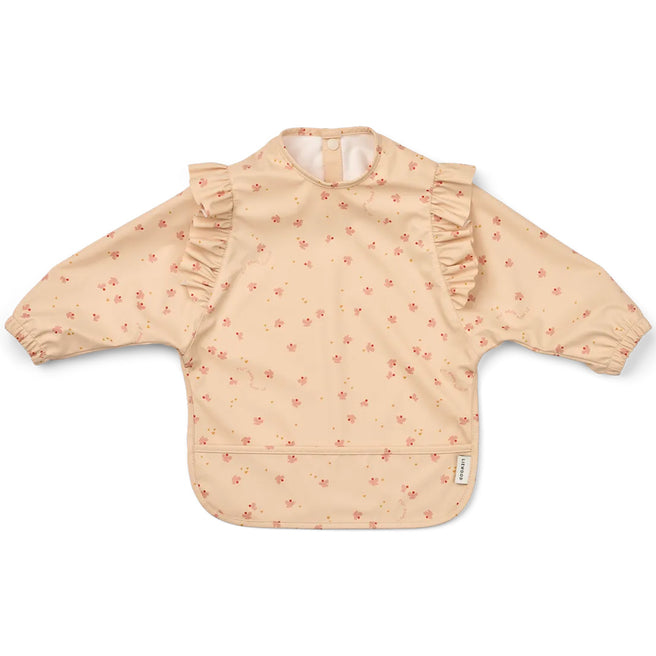 Liewood mouwslab met ruches en voorvakje, beige met roze bloemetjespatroon.