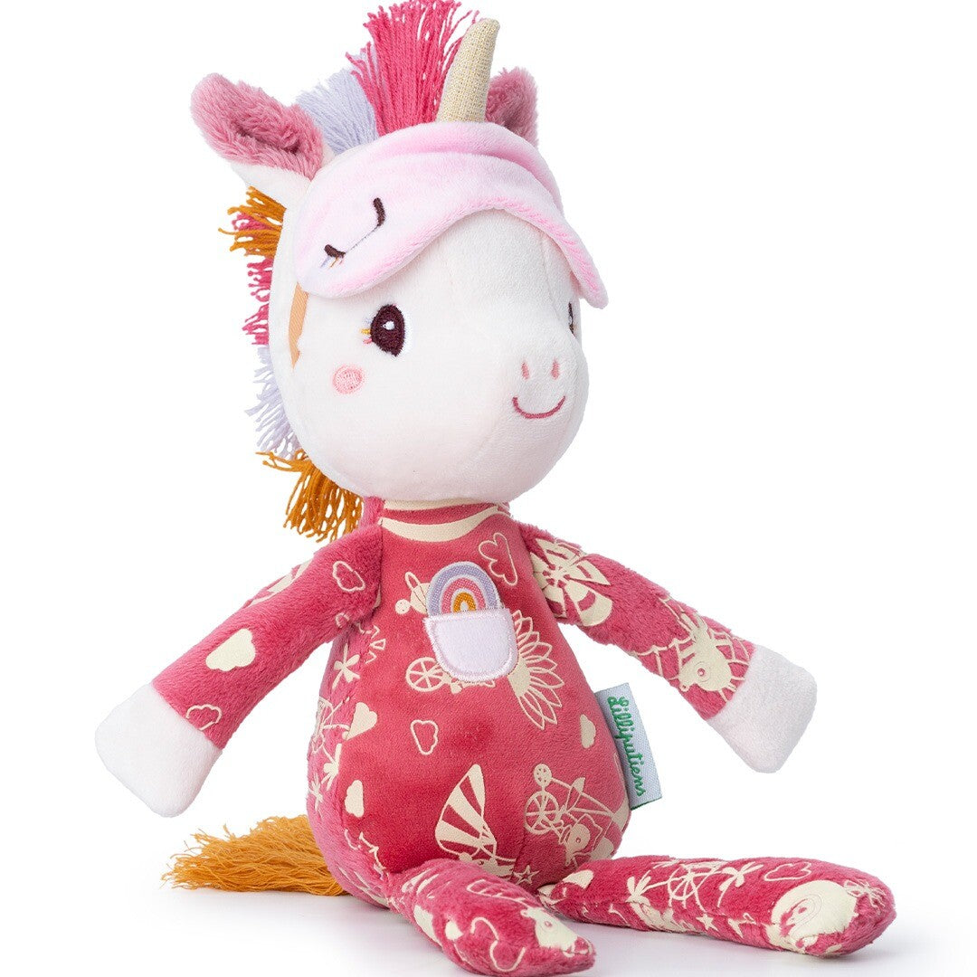 Lilliputiens pluchen eenhoorn knuffel Lena met roze pyjama en slaapmasker, zittend afgebeeld.