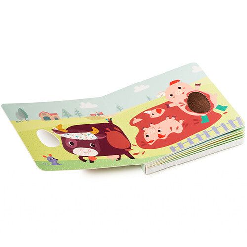 Een open Lilliputiens voelboek met geluiden toont een stier en varkens met voelbare texturen.