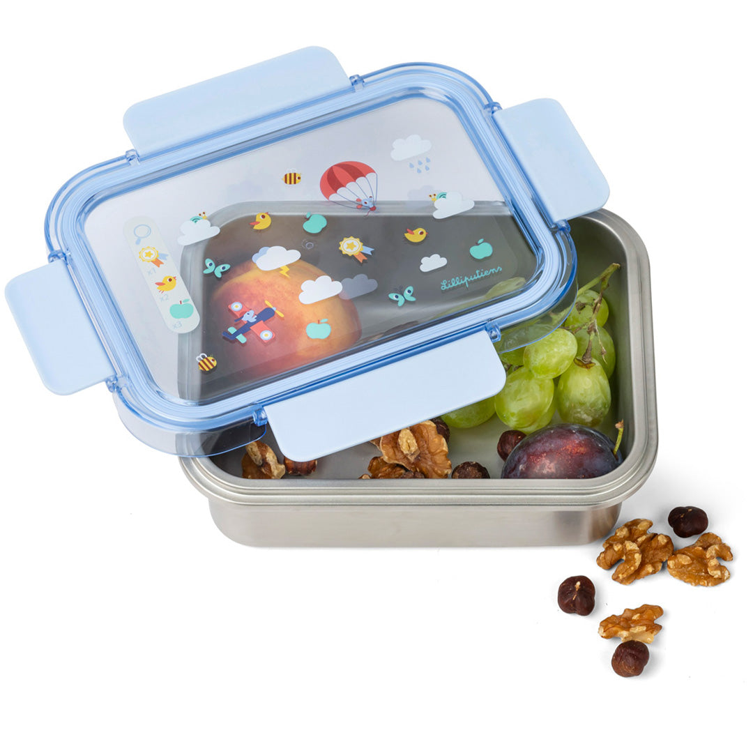 Open rvs broodtrommel met blauw deksel en illustraties, gevuld met fruit en noten.
