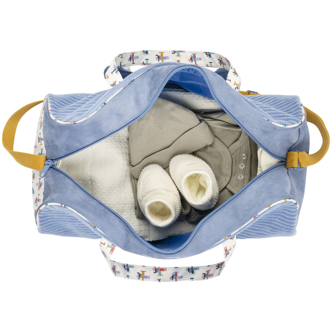 De open weekendtas, van bovenaf gezien, gevuld met babykleding.