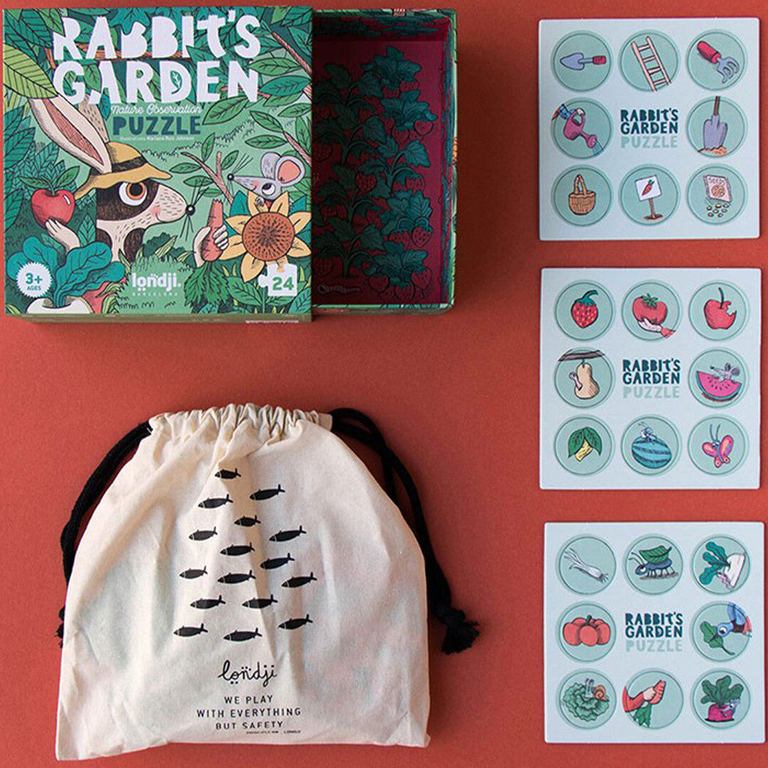 De open verpakking van de londji Rabbit's Garden puzzel, een stoffen zakje en drie kaarten met zoekspel-tokens.