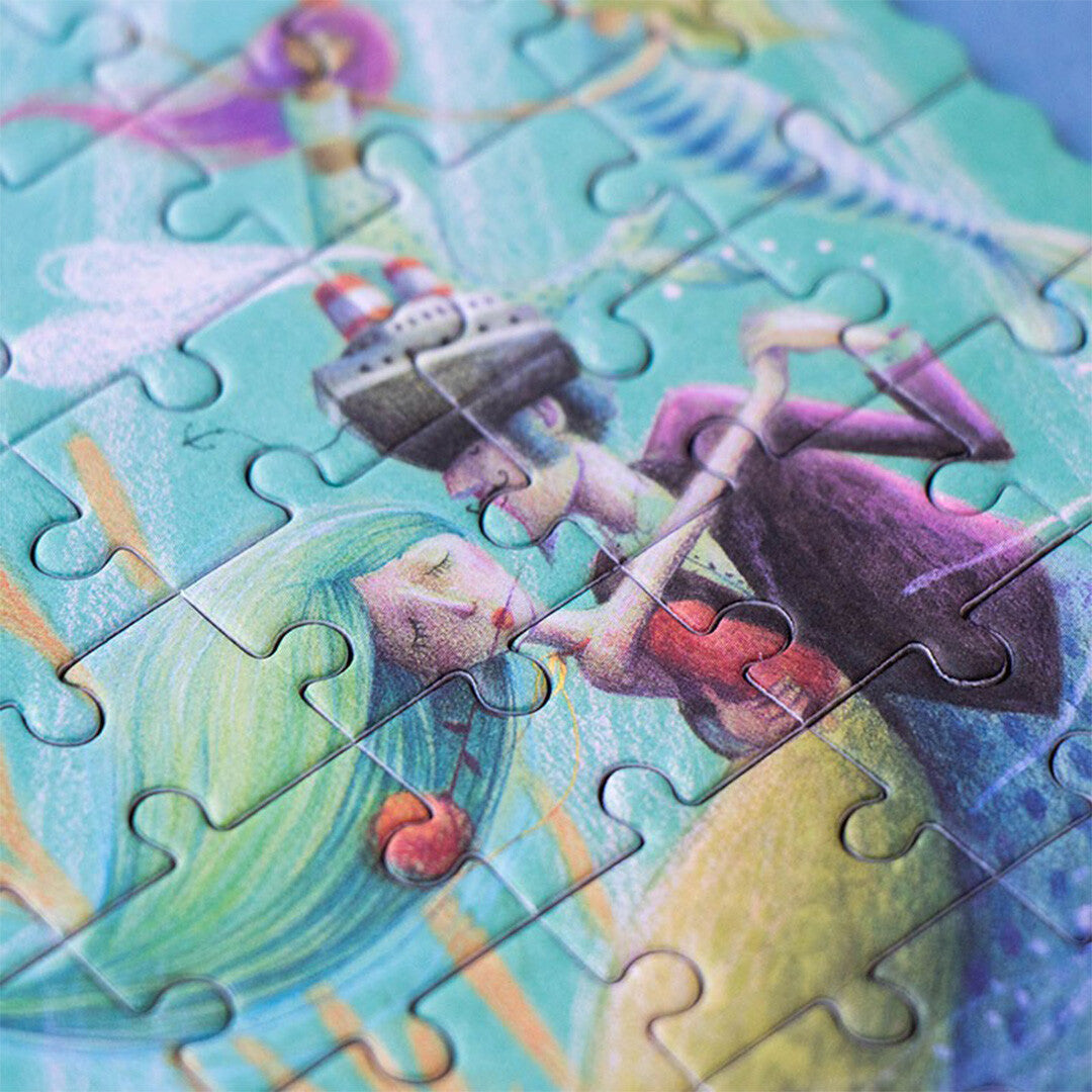 Detail van de Londji legpuzzel waarop een merman een zeemeermin kust.