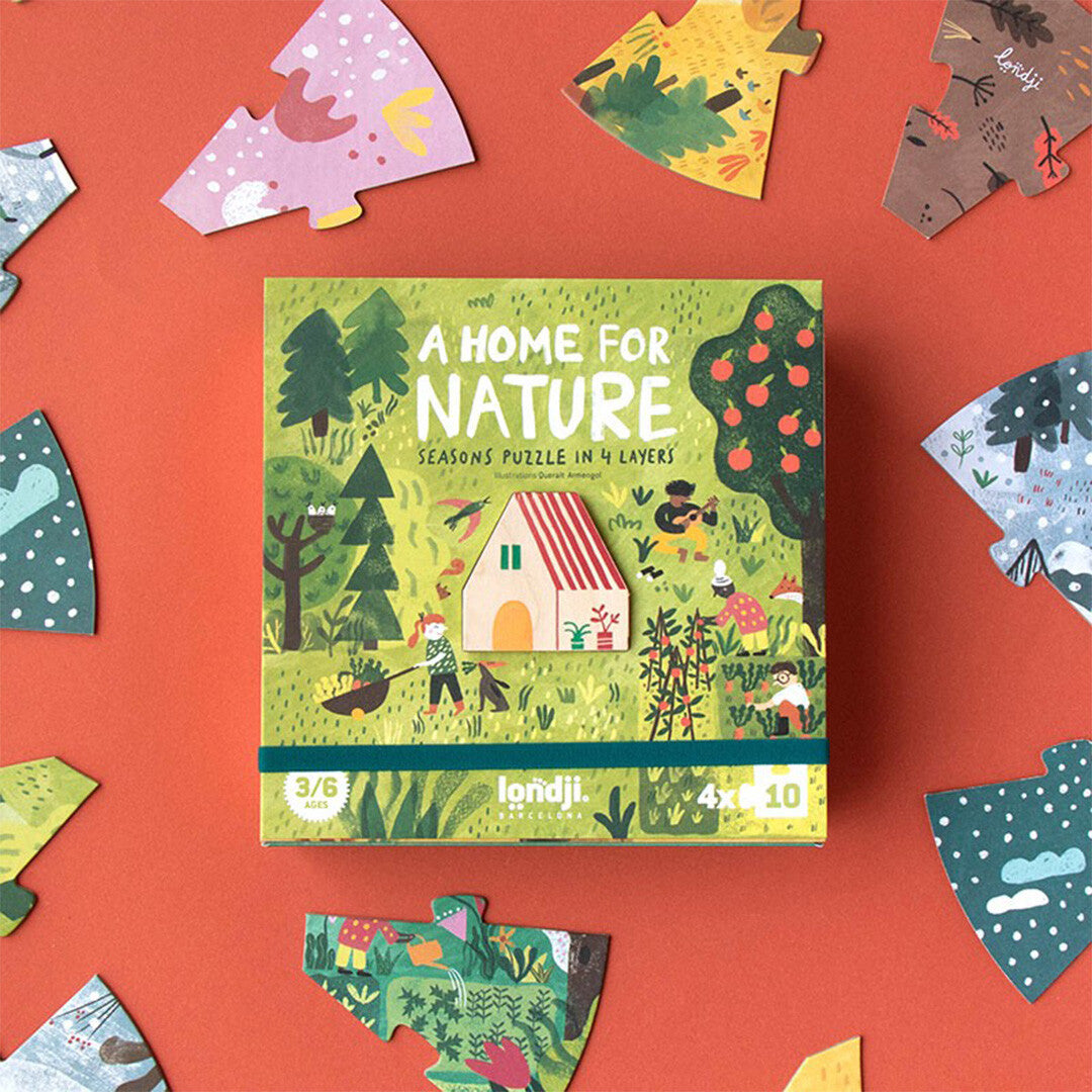 De Londji 'A Home for Nature' seizoenen legpuzzel verpakking omringd door diverse kleurrijke puzzelstukken.