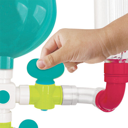 Een kinderhand draait aan een groene kraan van het Ludi badspeelgoed waterleiding.
