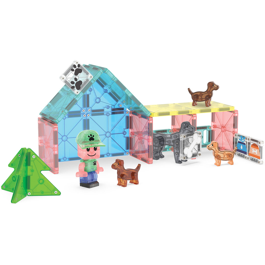 Magna-Tiles Puppy Park bouwset met een huis en omheining van magnetische tegels, puppy's en een kindfiguur.