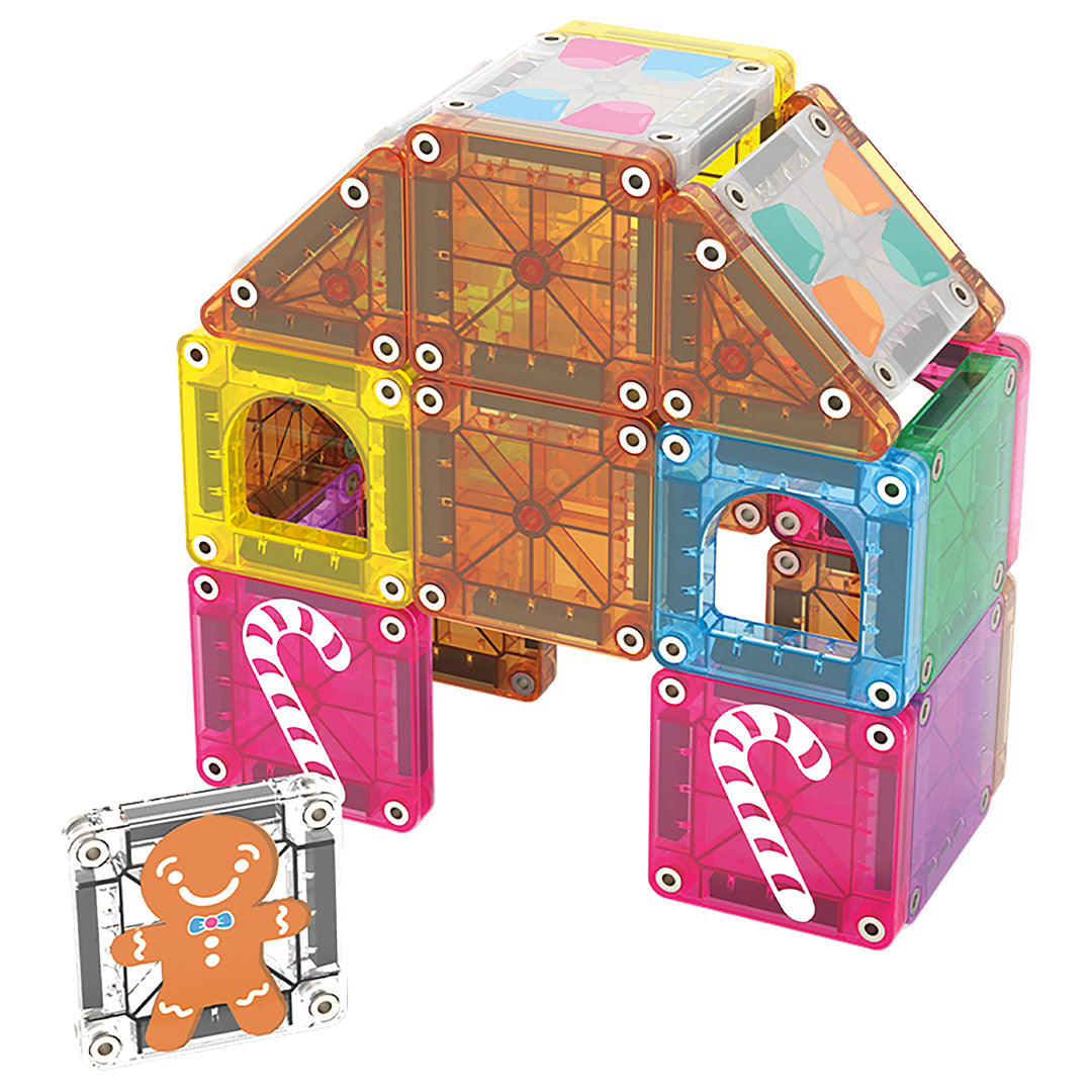 Een gebouwd peperkoekhuis van Magna-Tiles magnetische tegels met kerstthema, inclusief een losse koekjesman-tegel.