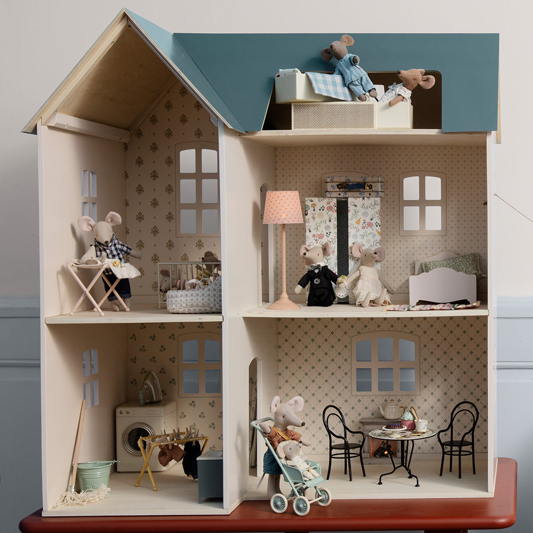 Maileg houten poppenhuis gevuld met Maileg muizenfiguren en meubels, die verschillende kamers gebruiken.