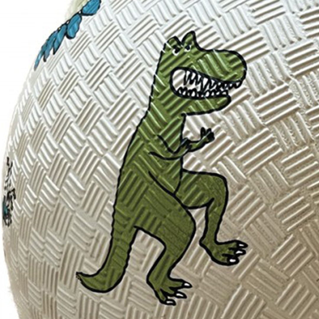 Detail van de Maison Petit Jour beige speelbal met een close-up van een groene T-Rex dinosaurus en de textuur.