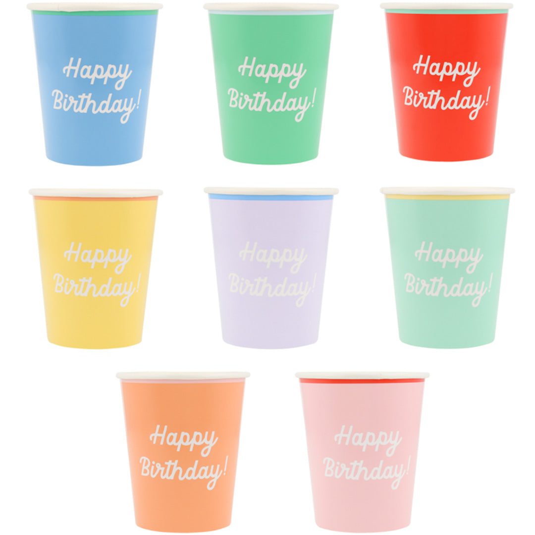 Zeven meri meri papieren verjaardagsbekers in verschillende kleuren met de tekst 'Happy Birthday!'.