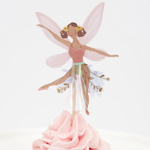 Detail van een cupcake met een feeën topper met bruin haar, roze vleugels en een roze jurk met iriserende details.