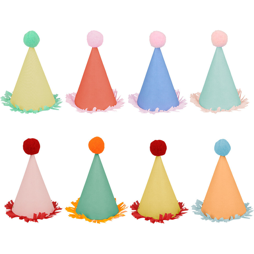 Acht kleurrijke Meri Meri mini feesthoedjes met pompons en franjes.