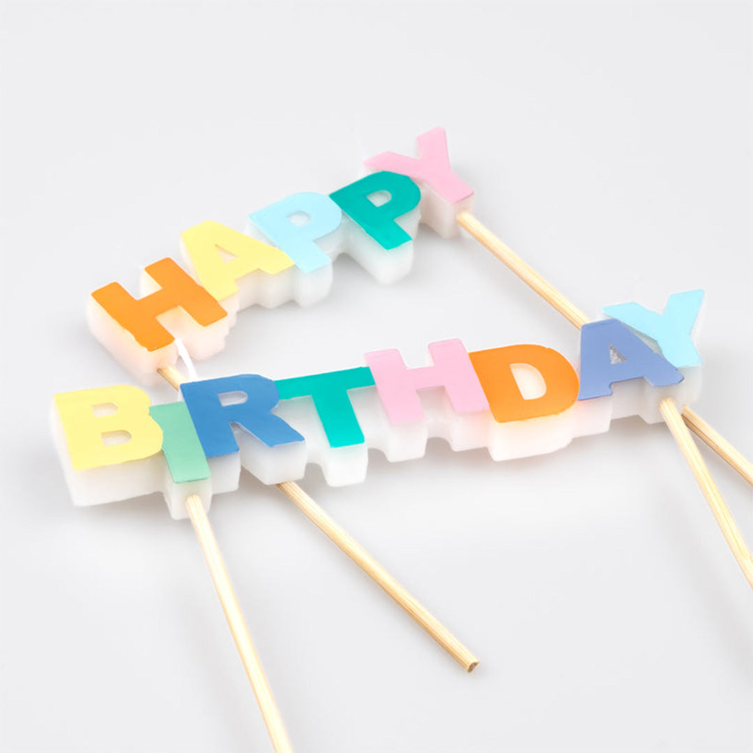 Schuine weergave van Meri Meri verjaardagskaarsen die de tekst 'Happy Birthday' vormen.