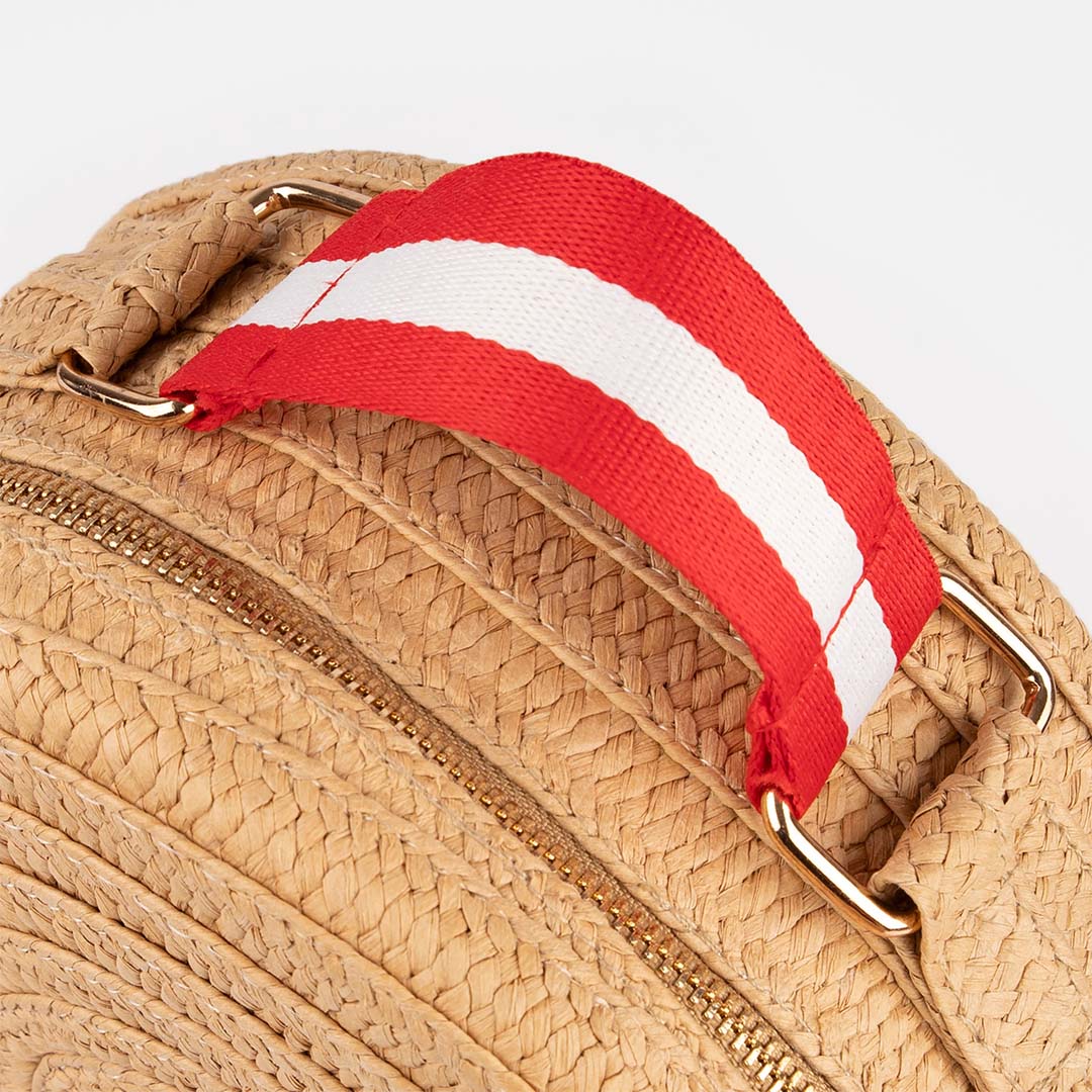 Bovenaanzicht van de rood-wit gestreepte hendel van de Meri Meri kinderhandtas met gouden bevestigingsringen.