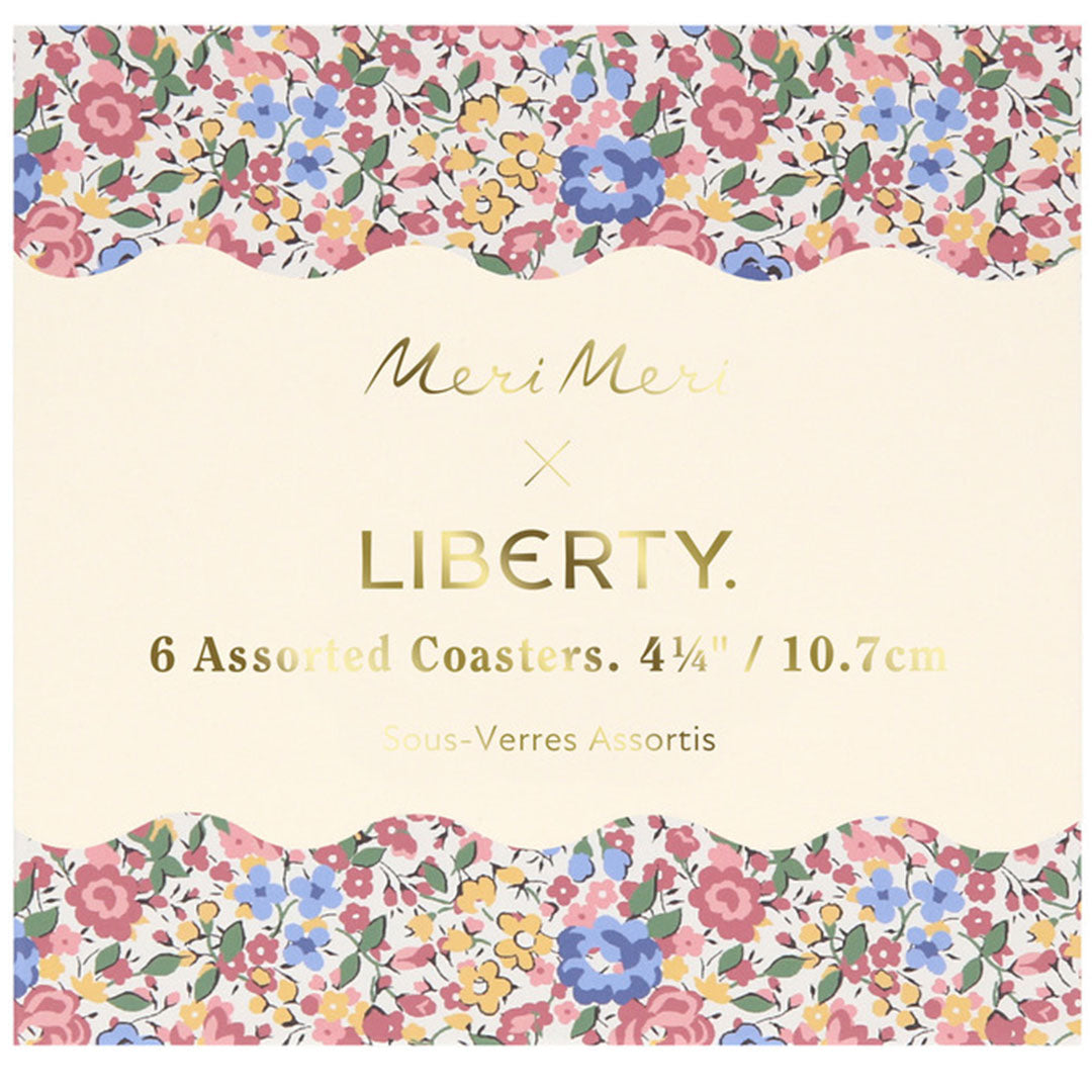 De verpakking van de Meri Meri x Liberty onderzetters met bloemmotieven en productinformatie.