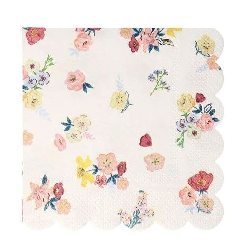 Meri Meri papieren servet met een patroon van verspreide kleurrijke bloemen en een geschulpte rand.