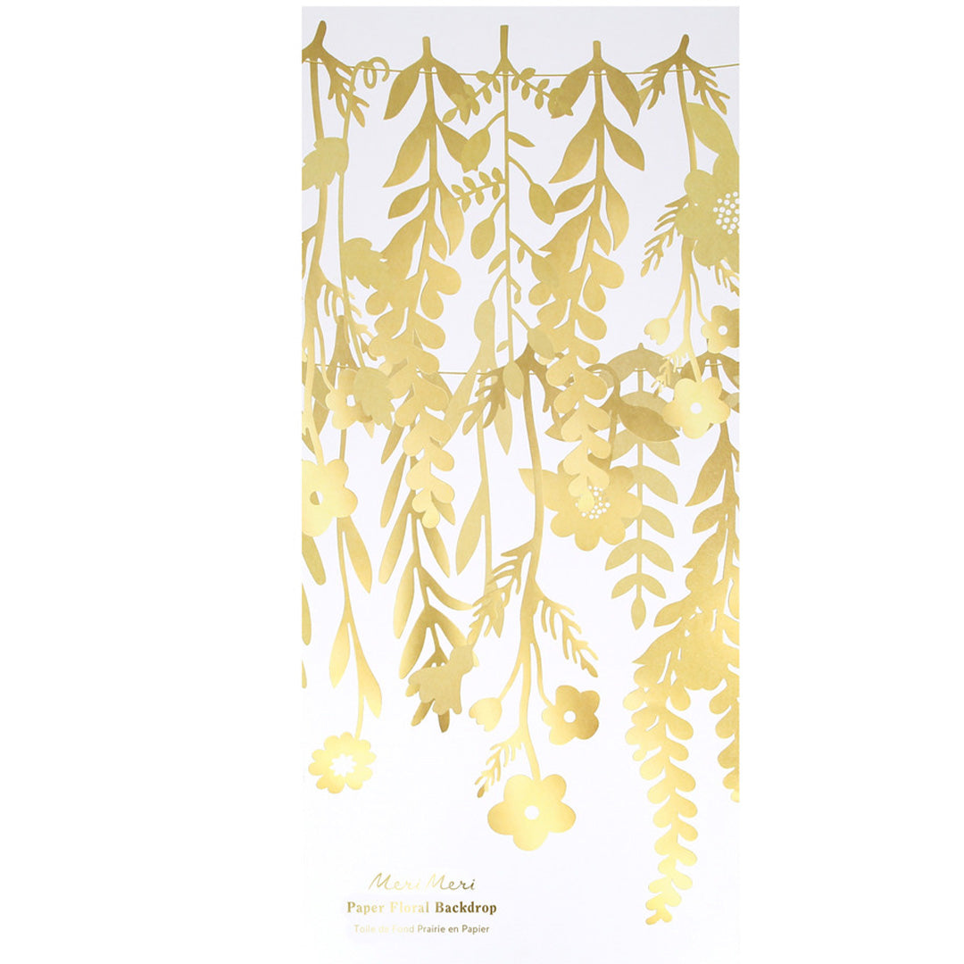 Verpakking van de Meri Meri gouden bloemenslinger met bloemen en bladeren.