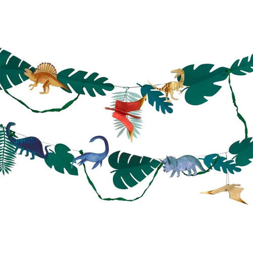 Meri Meri dinosaurus feestslinger met groene bladeren en diverse kleurrijke dinosaurusfiguren tegen een witte achtergrond.