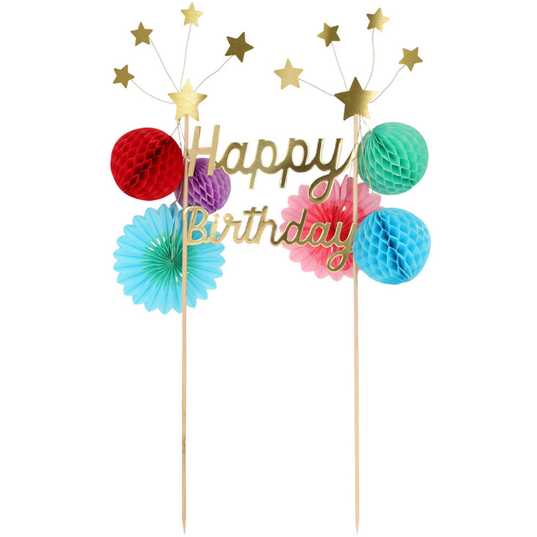 Meri Meri Happy Birthday taarttopper met gouden tekst, sterren en kleurrijke papieren decoraties.