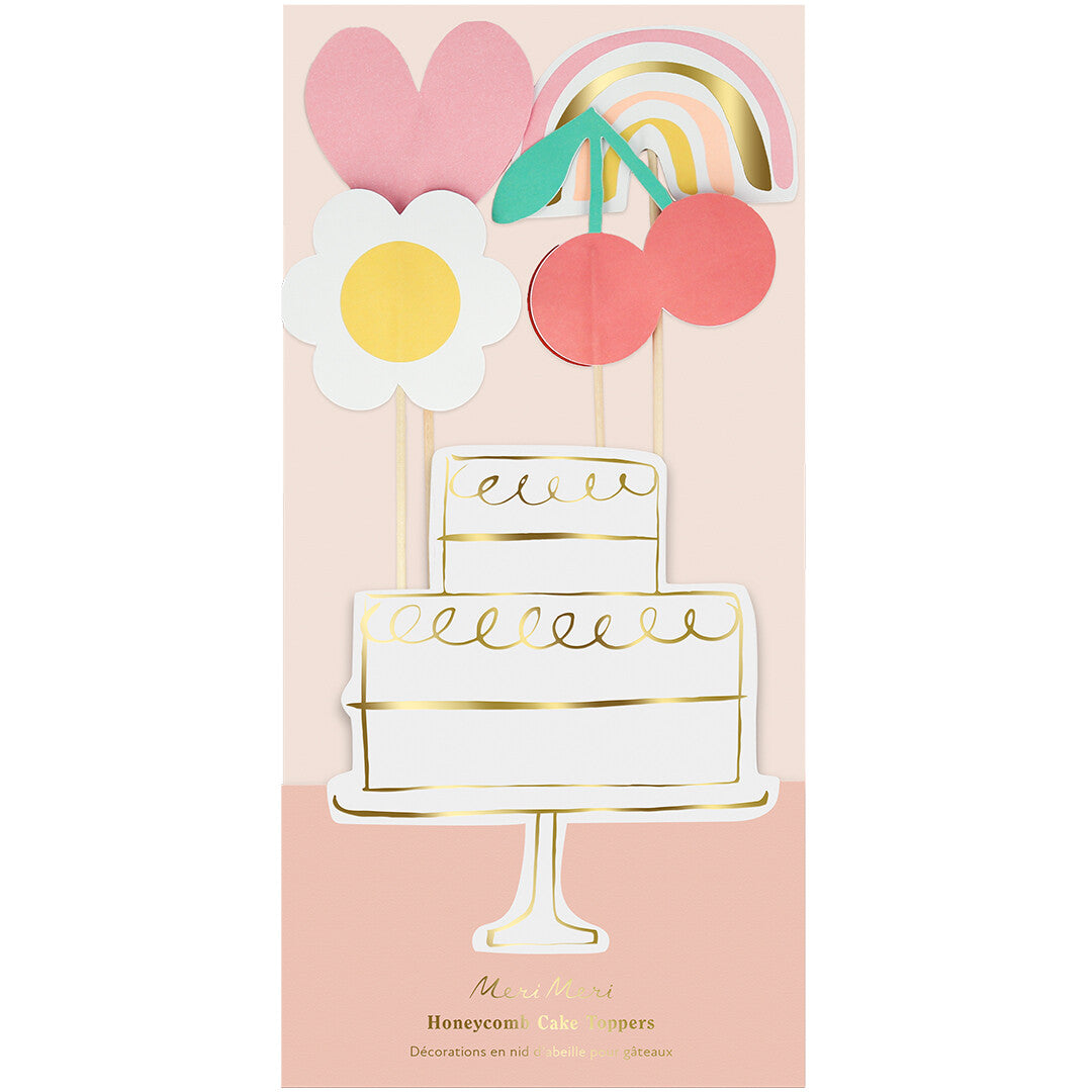 De verpakking van Meri Meri taartversiering met de vrolijke figuurtjes en een taartillustratie.