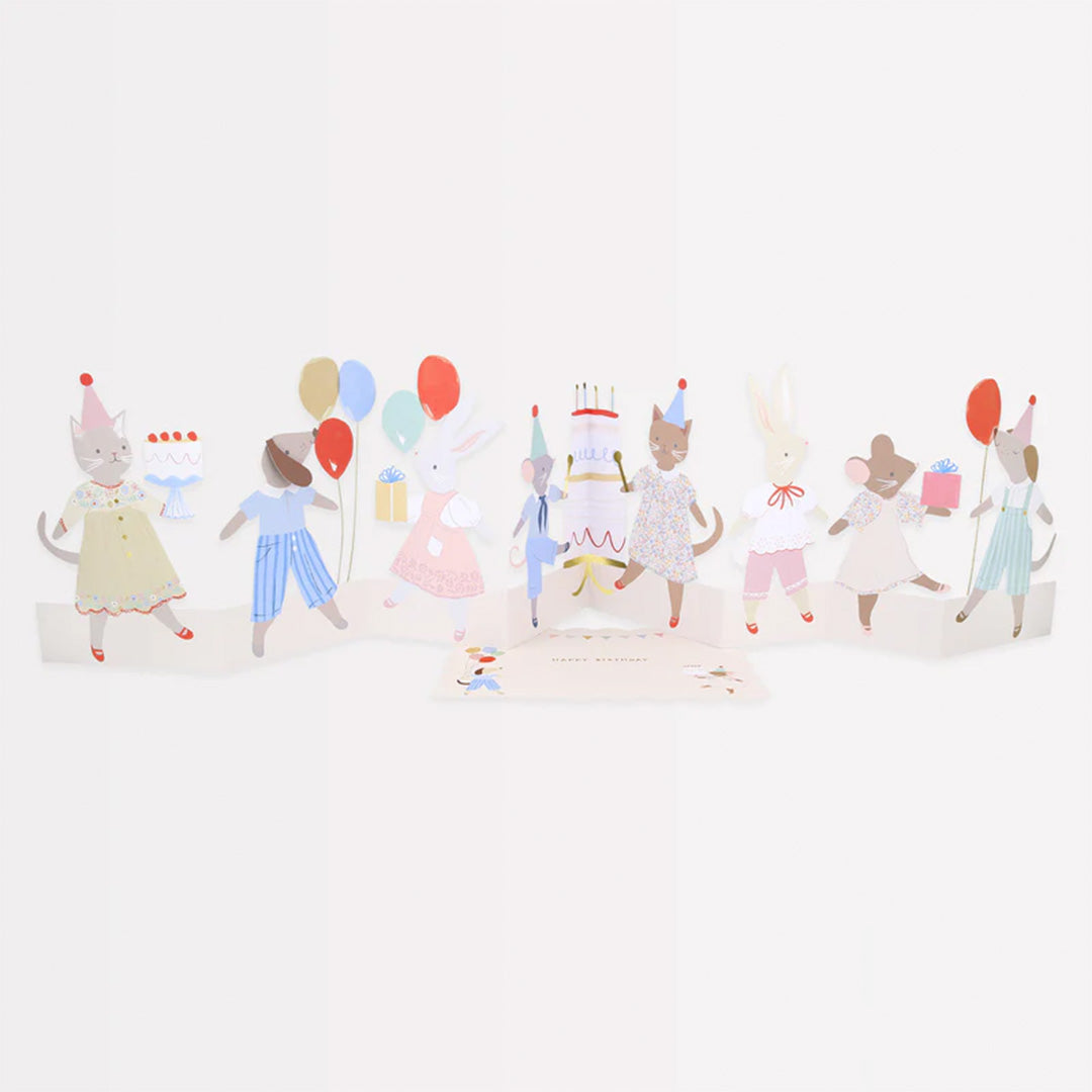 Meri Meri pop-up verjaardagskaart met een rij feestende dierenfiguren en een verjaardagstaart.