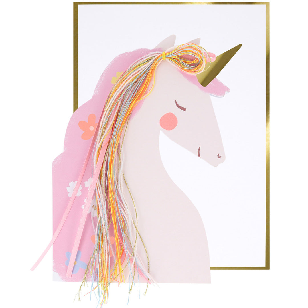 Meri Meri verjaardagskaart met een roze eenhoornhoofd en kleurrijke manen, op een witte achtergrond met gouden rand.