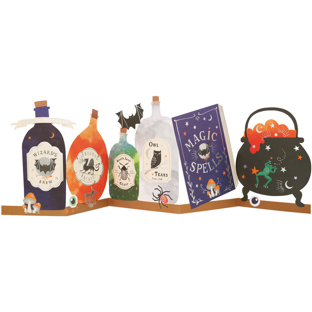 Meri meri pop-up verjaardagskaart met toverdrankflesjes, een spreukenboek en een heksenketel.