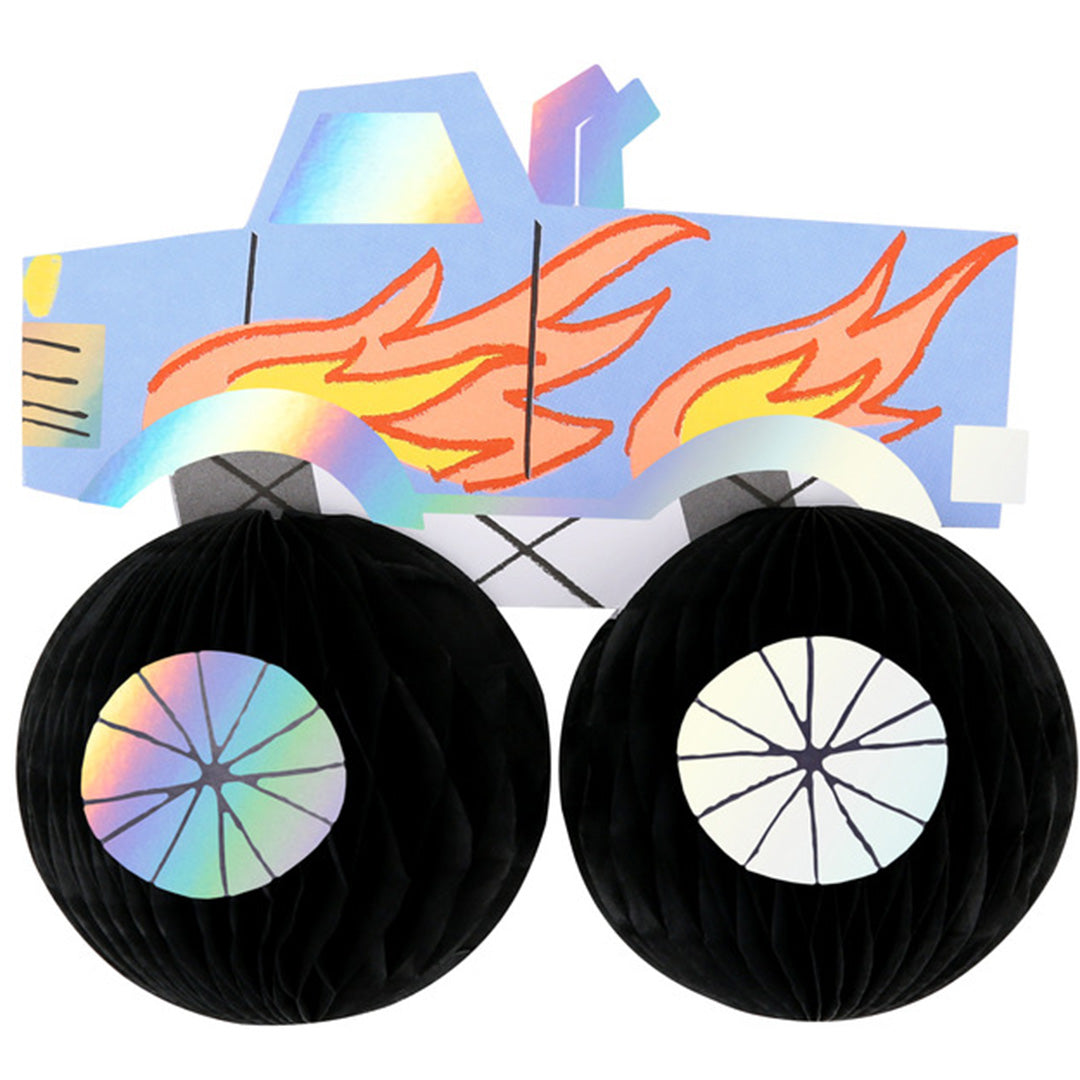 Meri Meri verjaardagskaart met een blauwe monster truck met vlammen en twee zwarte honingraatwielen.