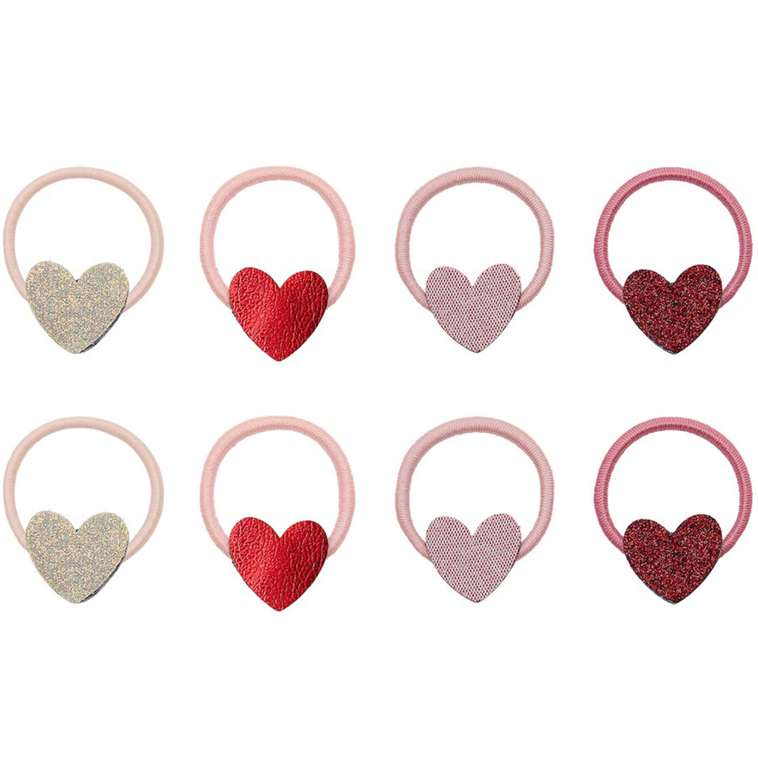mimi & lula haarelastiekjes voor kinderen met hartjes in verschillende roze, rode en gouden kleuren en texturen.